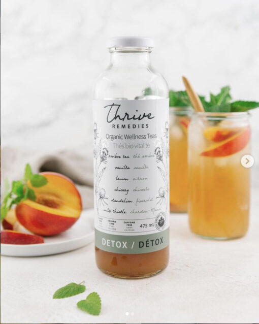 bottle of thrive remedies detox flavour with glasses of nectarine iced detox tea in the background